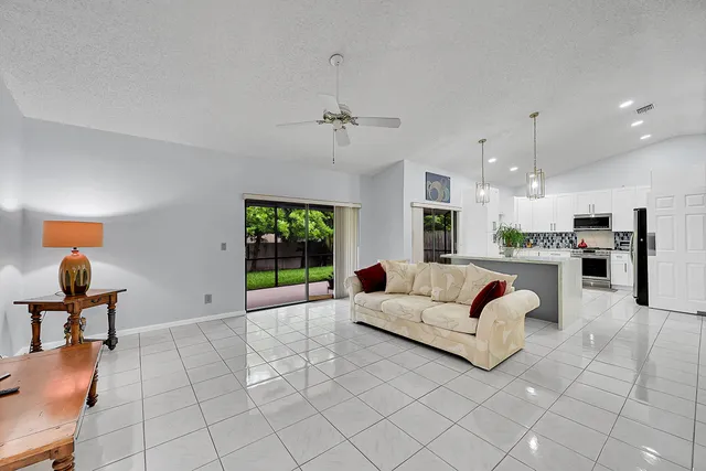 a living room with a bed furniture and a flat screen tv