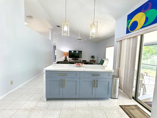 a view of a house with porch and potted plants