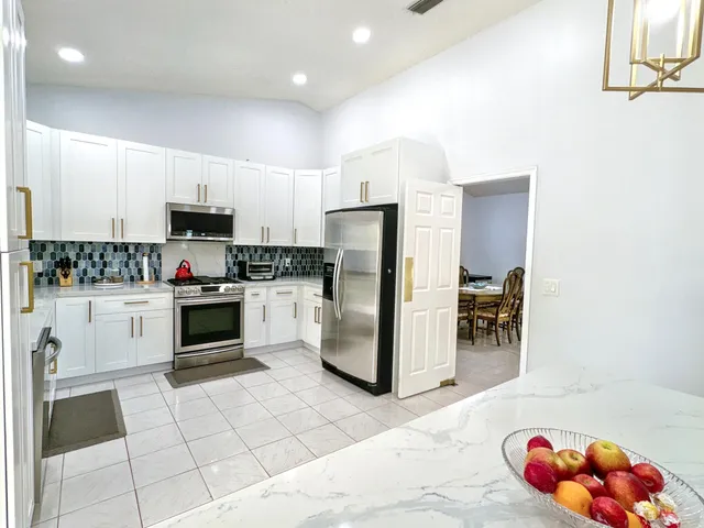 a view of a house with yard and a large tree