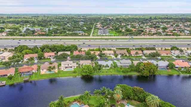 a large white kitchen with a large window