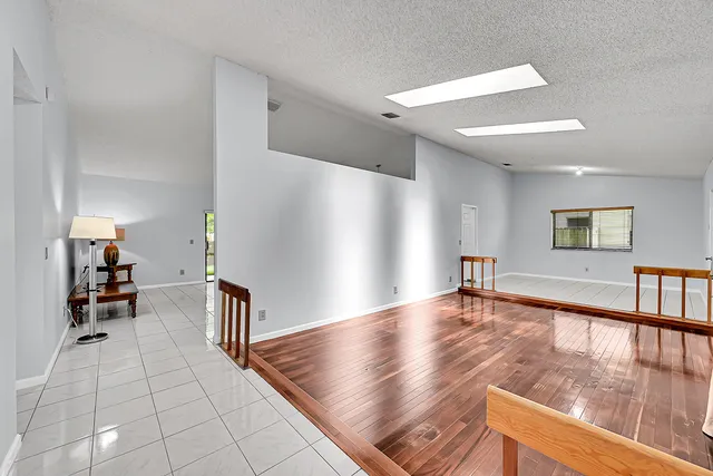 a kitchen with granite countertop a refrigerator and a stove top oven
