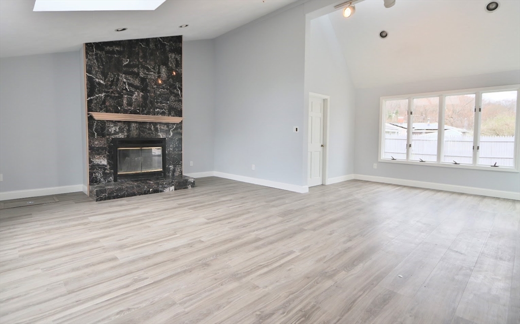 9 Poskus Road Framingham, MA 01701 - Photo 13 of 36 an empty room with wooden floor fireplace and windows