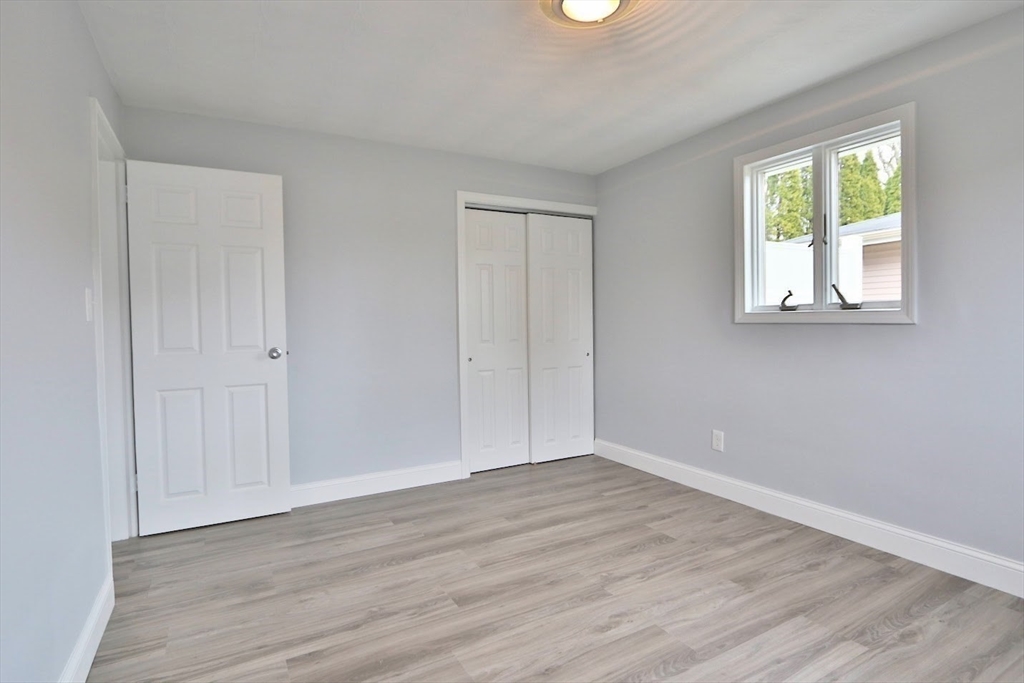 9 Poskus Road Framingham, MA 01701 - Photo 18 of 36 a view of an empty room with wooden floor and a window
