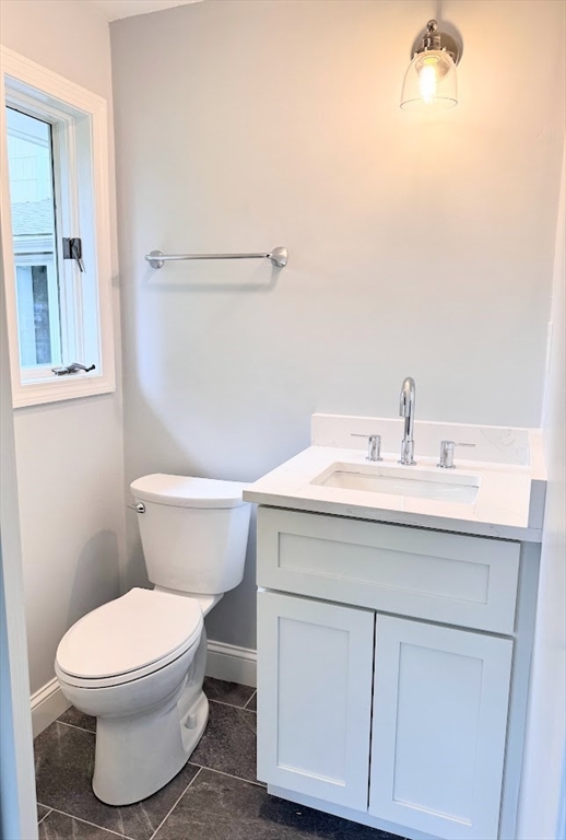 9 Poskus Road Framingham, MA 01701 - Photo 30 of 36 a bathroom with a sink mirror vanity and toilet