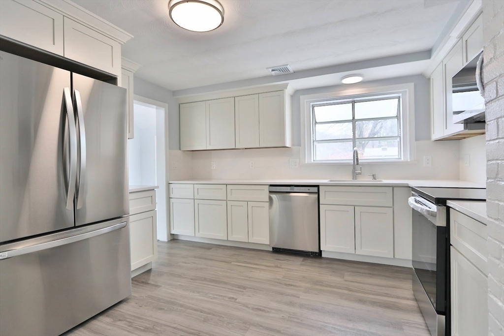 9 Poskus Road Framingham, MA 01701 - Photo 4 of 36 a kitchen with granite countertop a refrigerator sink and cabinets