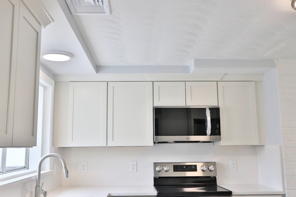 9 Poskus Road Framingham, MA 01701 - Photo 5 of 36 a view of kitchen and microwave