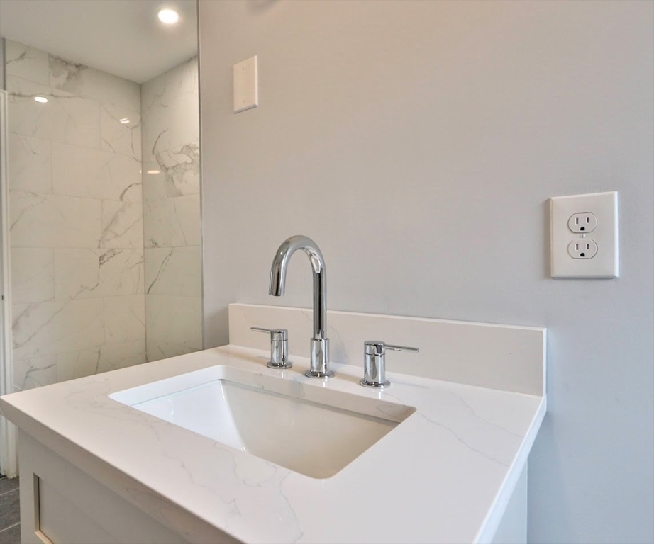 9 Poskus Road Framingham, MA 01701 - Photo 9 of 36 a bathroom with a sink and a mirror