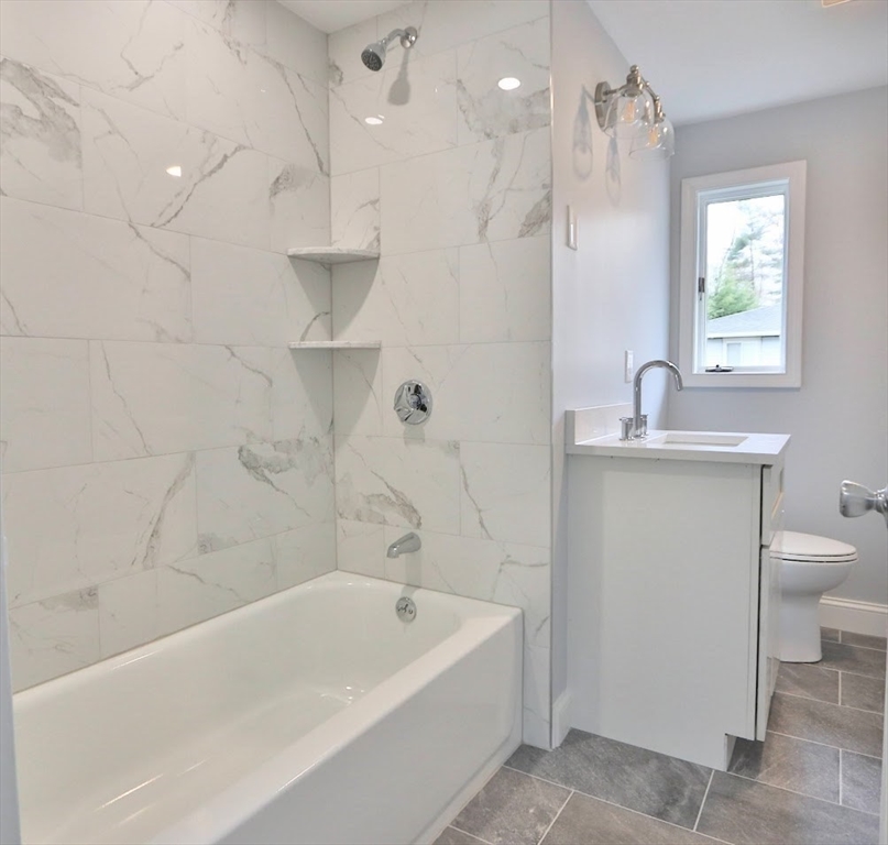 9 Poskus Road Framingham, MA 01701 - Photo 10 of 36 a bathroom with a tub a sink and a shower