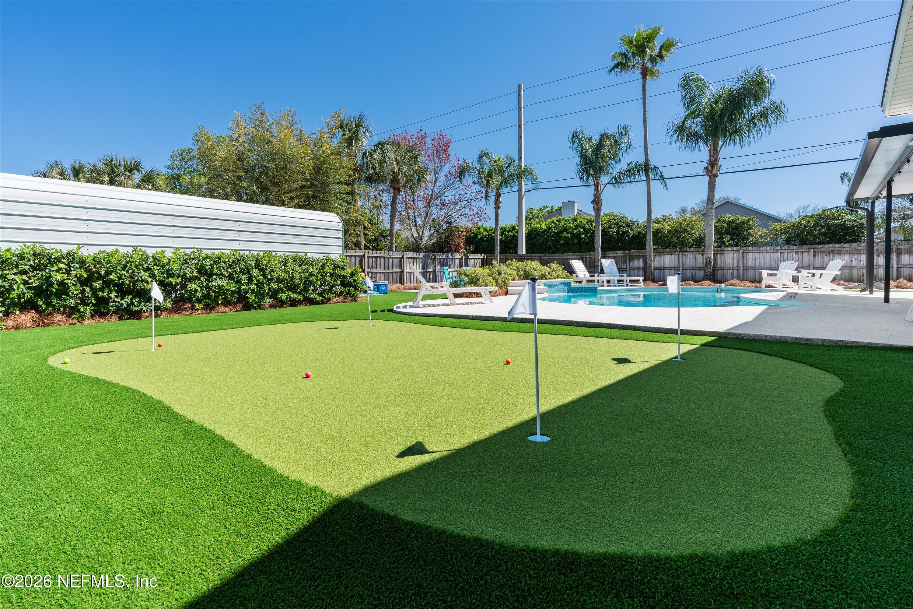 31 Norberta Way Jacksonville Beach, FL 32250 - Photo 11 of 49 a view of a swimming pool with a garden and trees