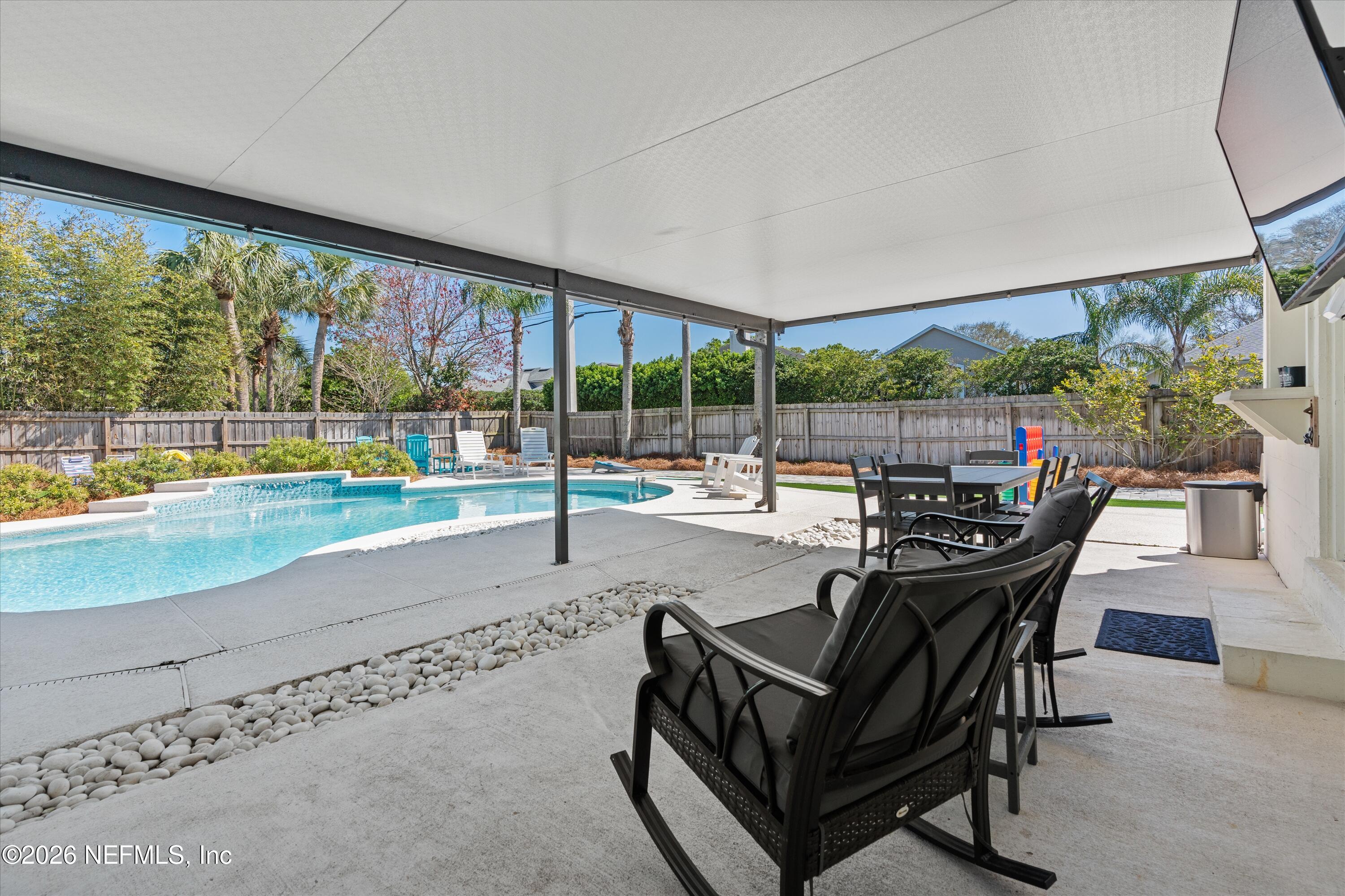 31 Norberta Way Jacksonville Beach, FL 32250 - Photo 13 of 49 a living room with patio furniture and a floor to ceiling window