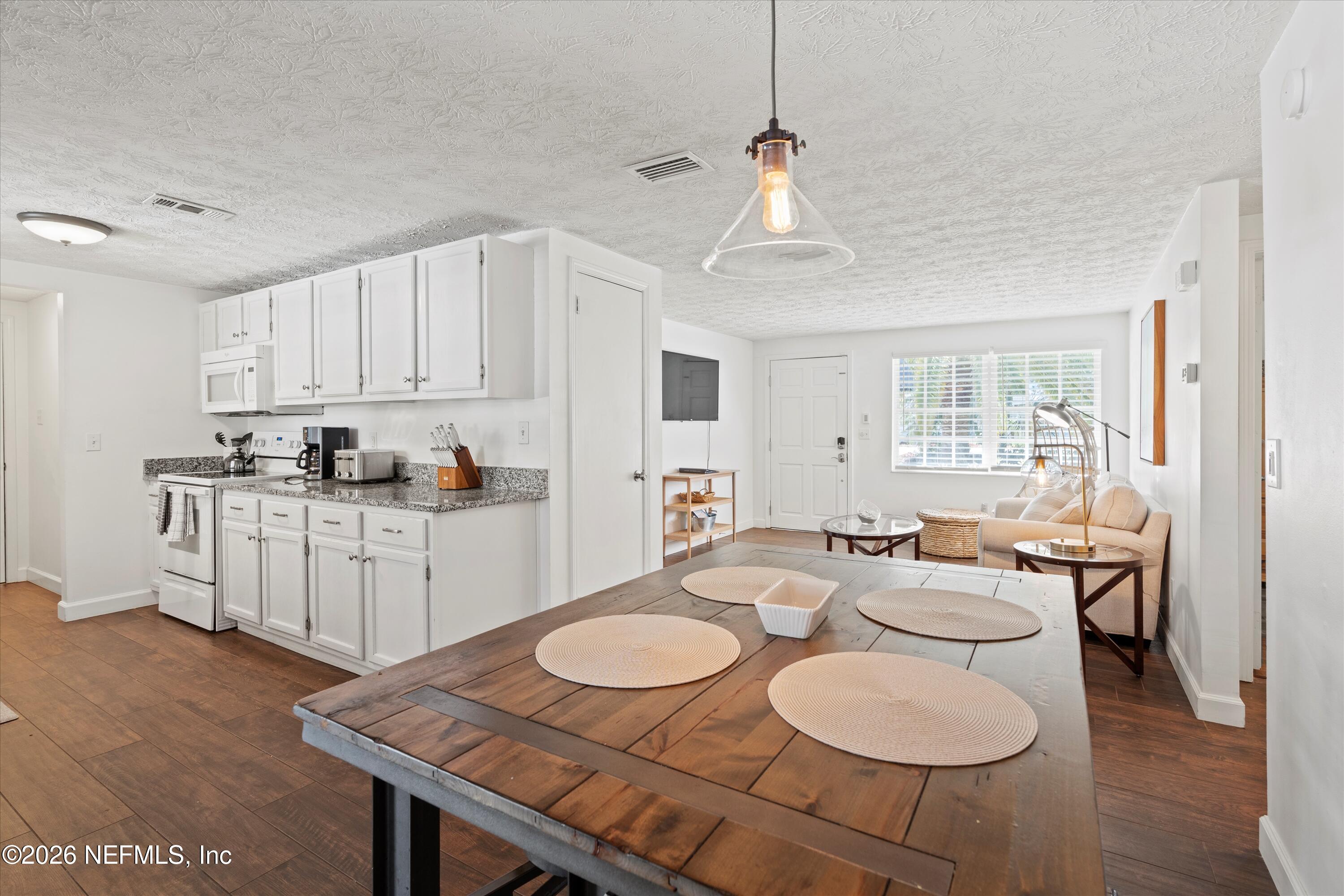 31 Norberta Way Jacksonville Beach, FL 32250 - Photo 28 of 49 a open dining room with furniture and wooden floor