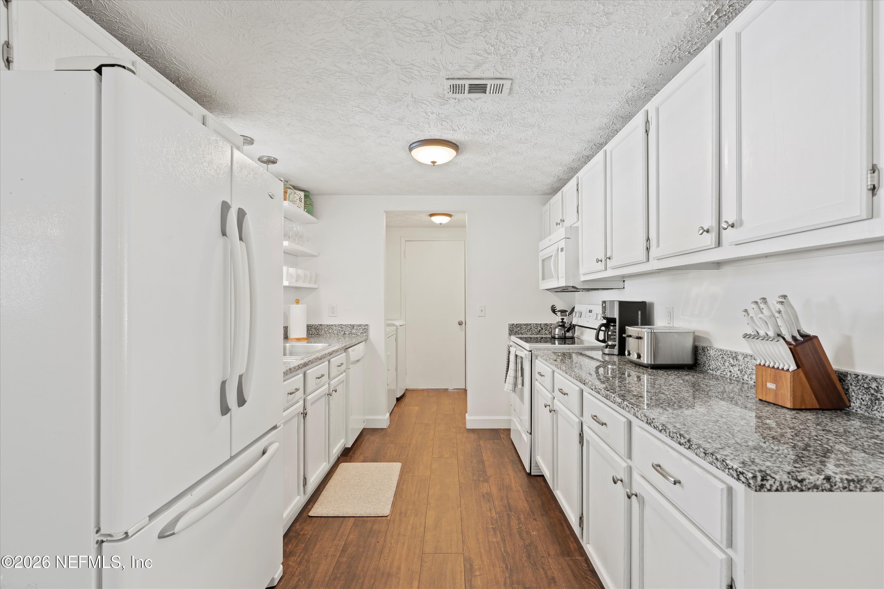 31 Norberta Way Jacksonville Beach, FL 32250 - Photo 31 of 49 a kitchen with granite countertop lots of counter top space and stainless steel appliances