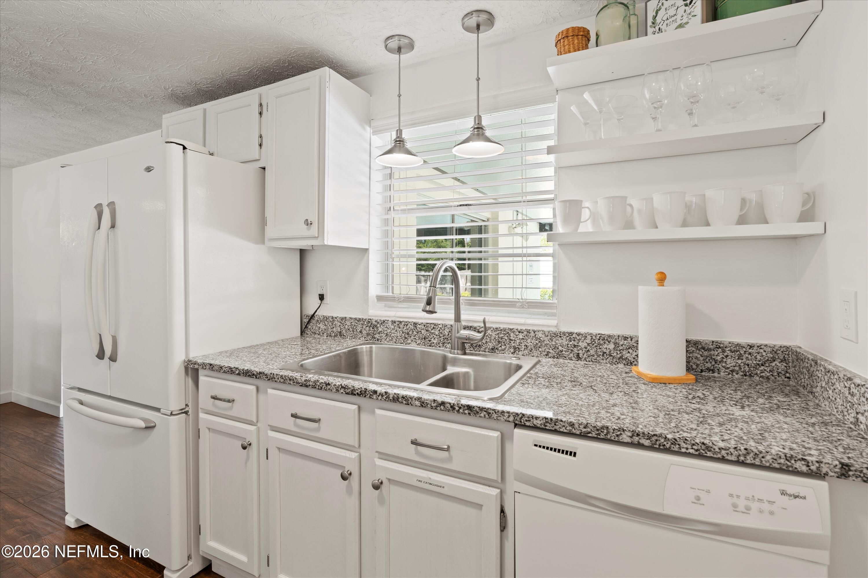 31 Norberta Way Jacksonville Beach, FL 32250 - Photo 33 of 49 a kitchen with kitchen island a sink stainless steel appliances and cabinets