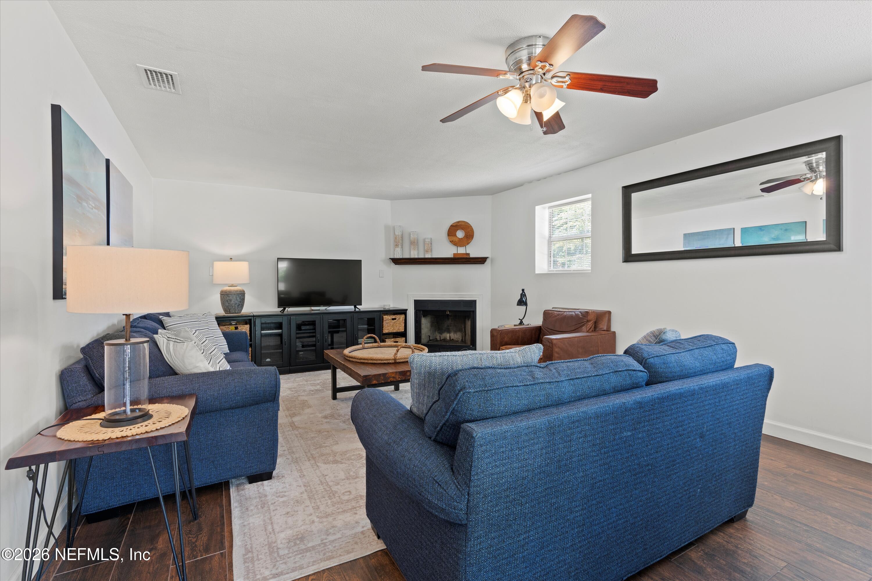 31 Norberta Way Jacksonville Beach, FL 32250 - Photo 35 of 49 a living room with furniture a fireplace and a flat screen tv