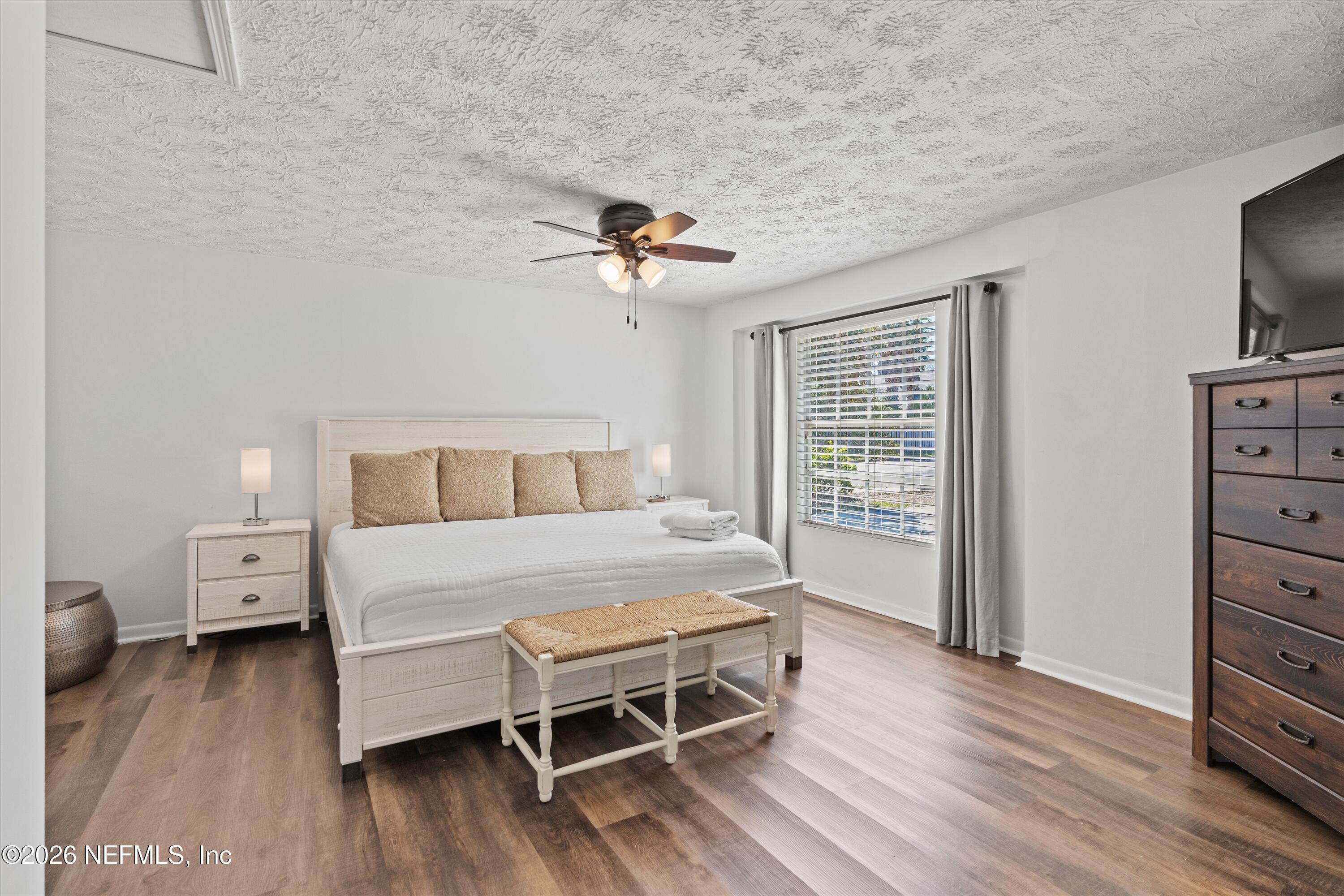 31 Norberta Way Jacksonville Beach, FL 32250 - Photo 38 of 49 a bedroom with a bed and wooden floor