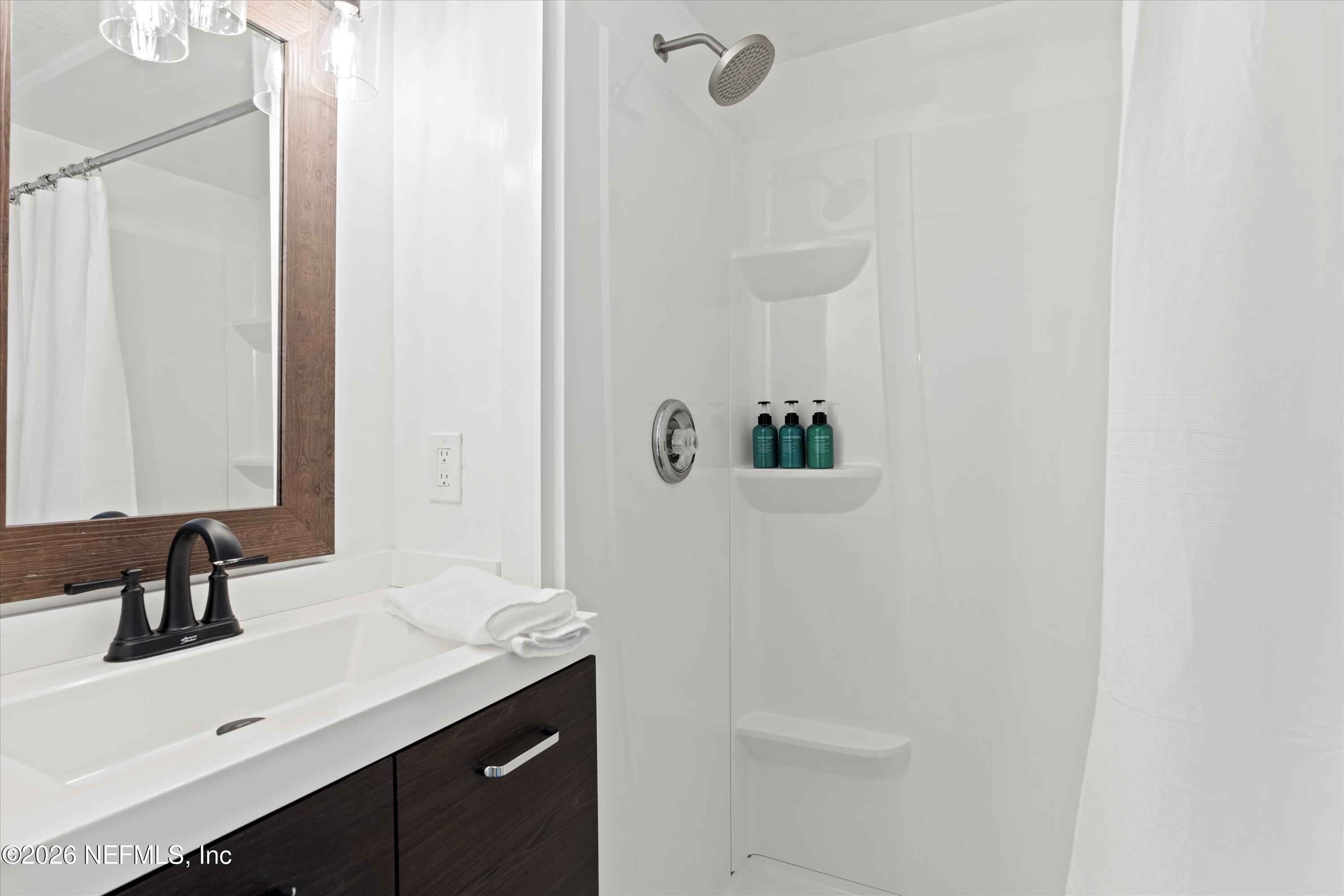 31 Norberta Way Jacksonville Beach, FL 32250 - Photo 39 of 49 a bathroom with a sink and a mirror