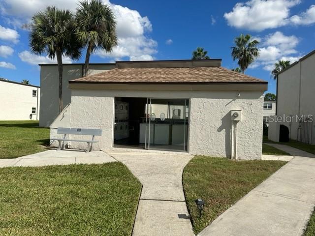 7701 Starkey Road, Unit 731 Seminole, FL 33777 - Photo 11 of 19 a front view of a house with garden