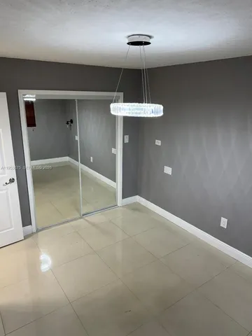 a bathroom with a granite countertop sink toilet a mirror and shower