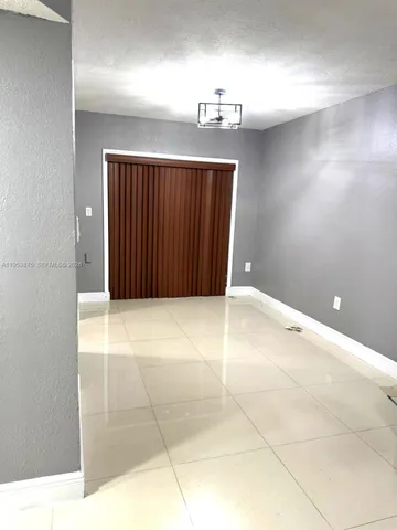 a view of an empty room with a bathroom