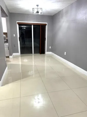 a white toilet sitting next to a white sink and vanity