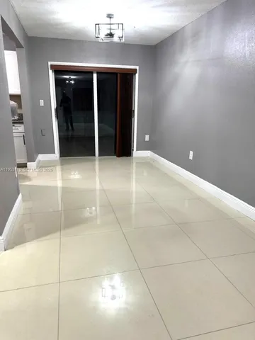 a white toilet sitting next to a white sink and vanity