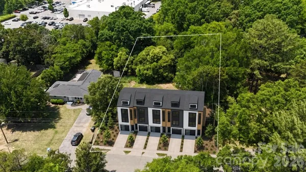 an aerial view of a house with swimming pool and garden