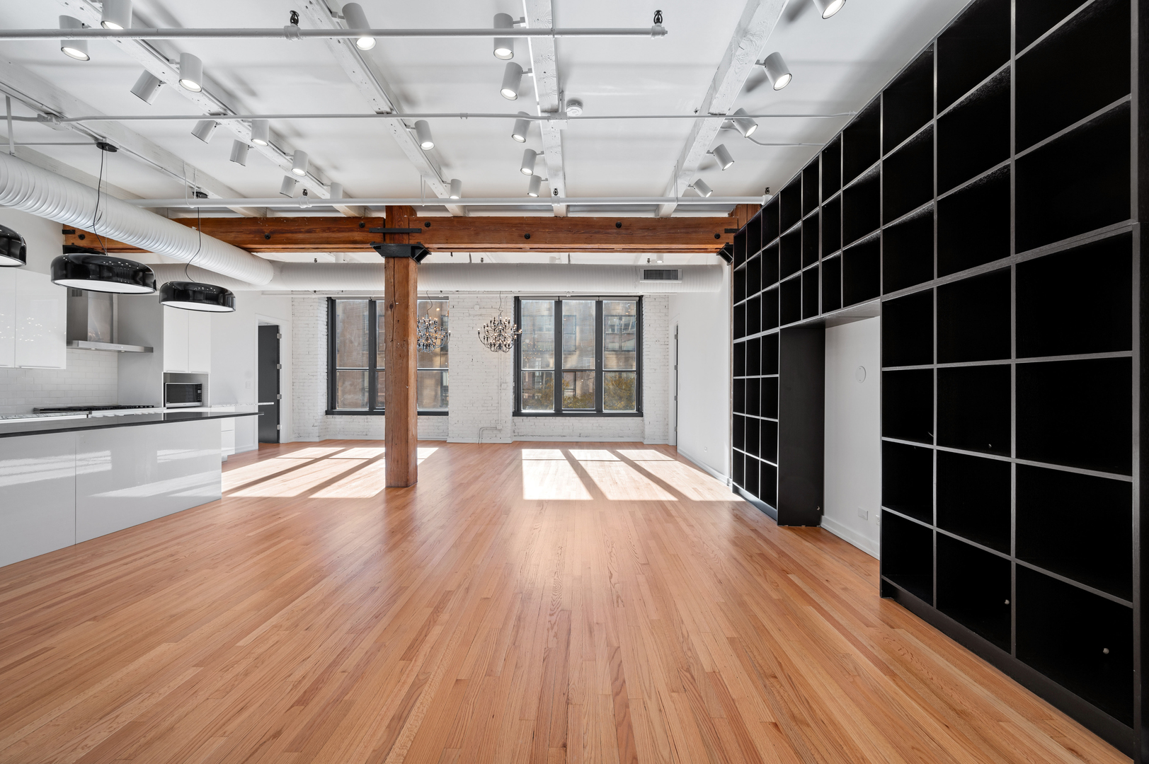 900 West Jackson Boulevard, Unit 3W Chicago, IL 60607 - Photo 14 of 38 a view of empty room with wooden floor and windows
