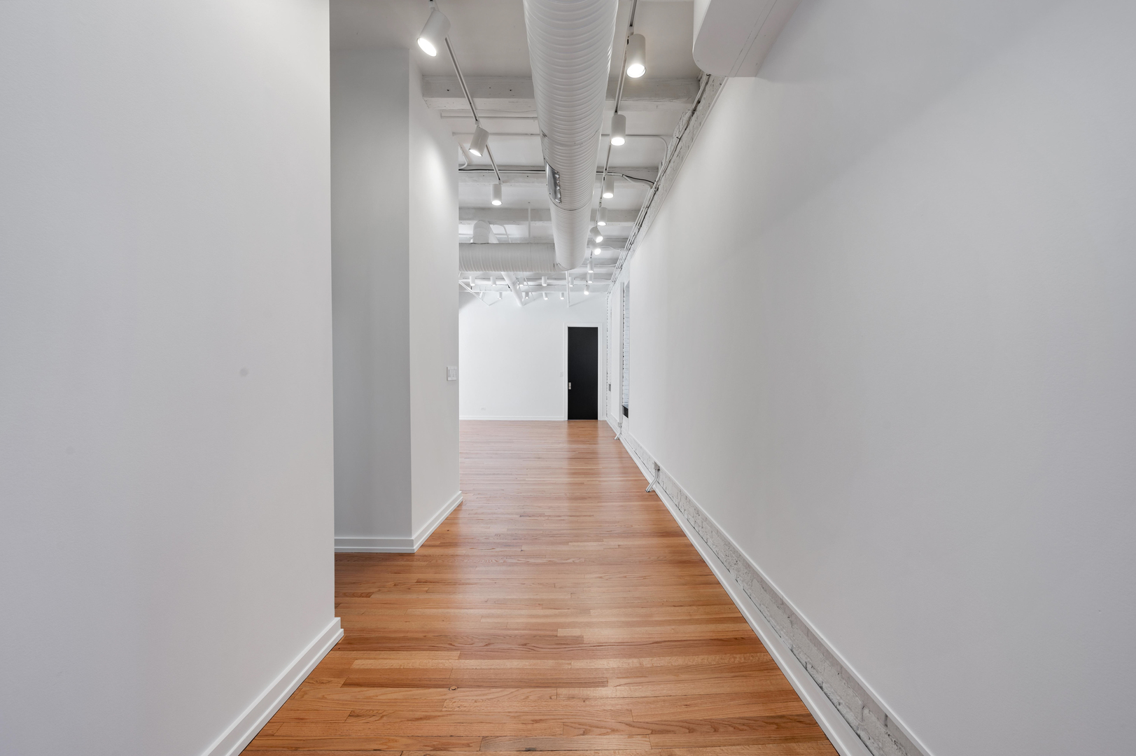900 West Jackson Boulevard, Unit 3W Chicago, IL 60607 - Photo 5 of 38 a view of a hallway with wooden floor and staircase