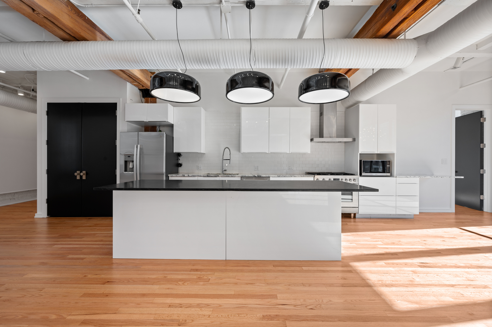 900 West Jackson Boulevard, Unit 3W Chicago, IL 60607 - Photo 10 of 38 a kitchen with stainless steel appliances granite countertop a sink and a stove