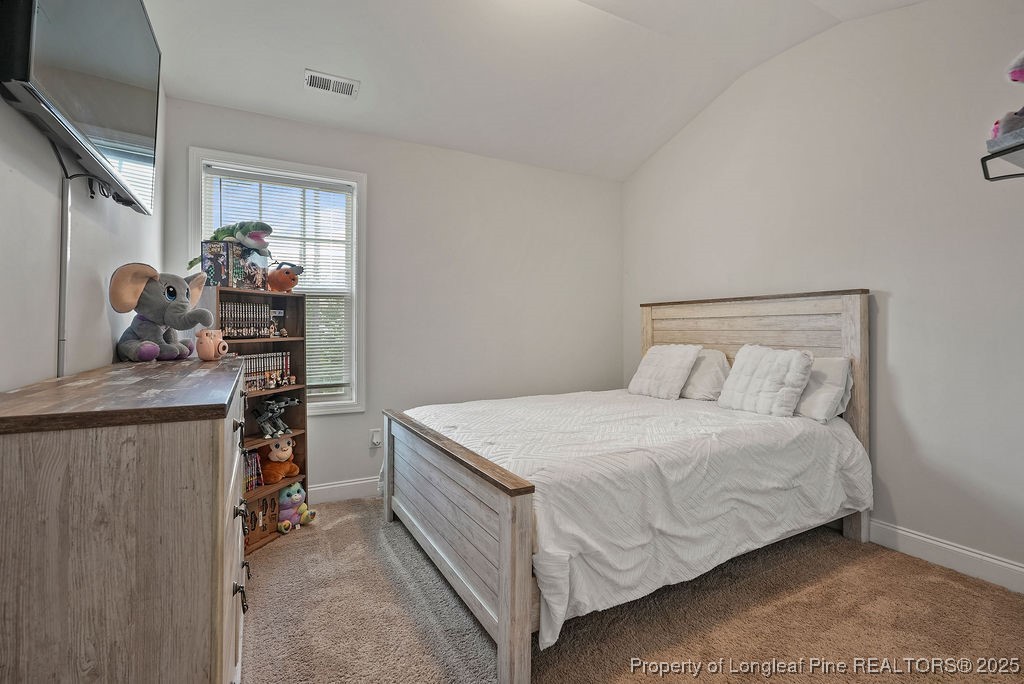 150 Timber Skip Drive Spring Lake, NC 28390 - Photo 22 of 39 a bedroom with a bed and a table