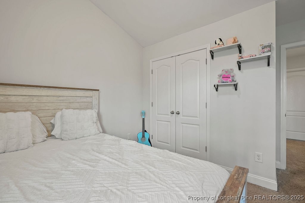 150 Timber Skip Drive Spring Lake, NC 28390 - Photo 23 of 39 a bedroom with a bed and a closet