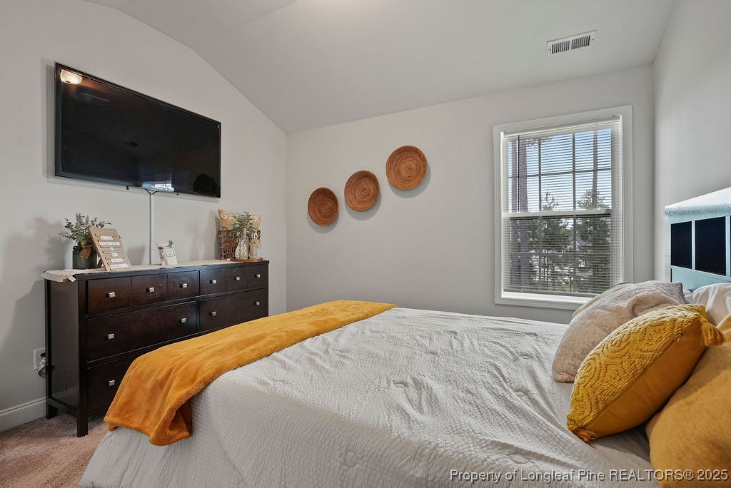 150 Timber Skip Drive Spring Lake, NC 28390 - Photo 28 of 39 a bedroom with a bed and flat screen tv