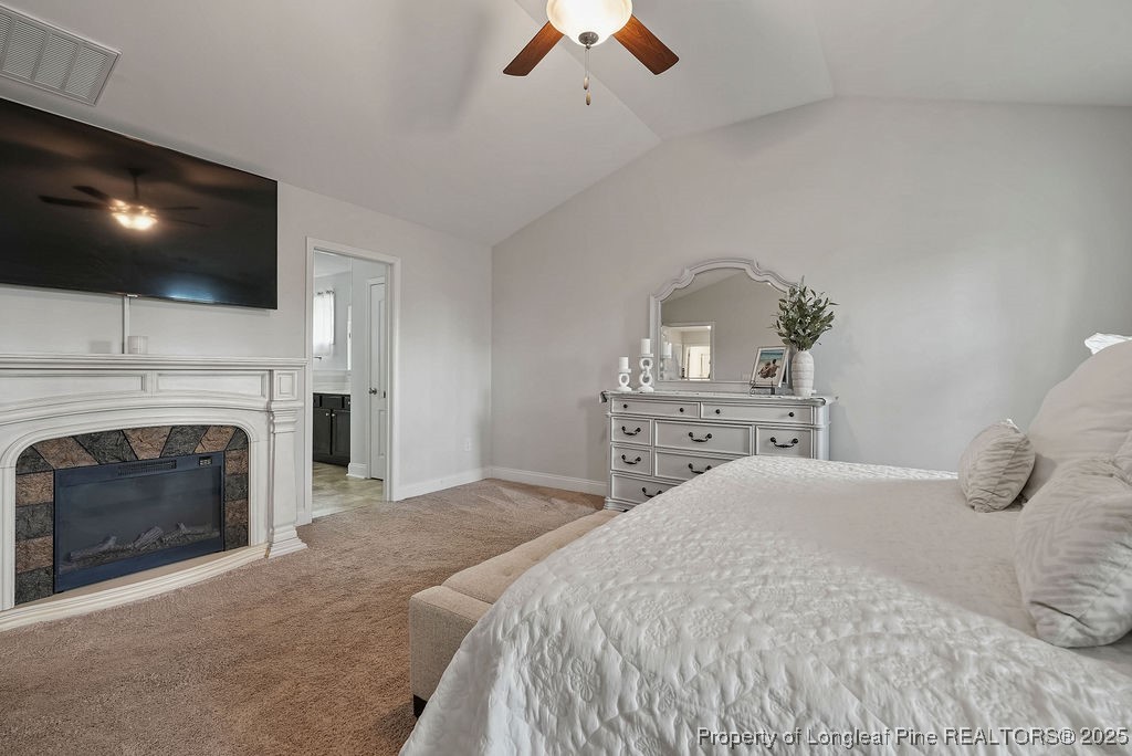 150 Timber Skip Drive Spring Lake, NC 28390 - Photo 34 of 39 a bedroom with a large bed and a flat screen tv