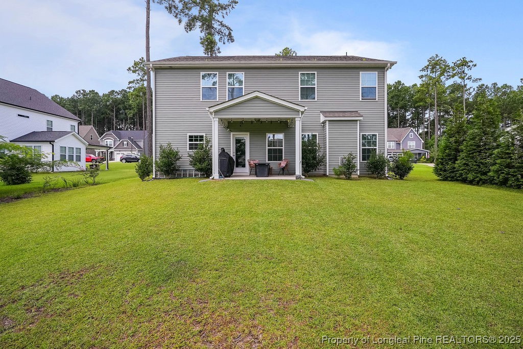 150 Timber Skip Drive Spring Lake, NC 28390 - Photo 39 of 39 a front view of a house with a garden and yard