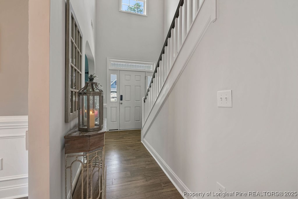 150 Timber Skip Drive Spring Lake, NC 28390 - Photo 5 of 39 a view of staircase with wooden floor and a rug
