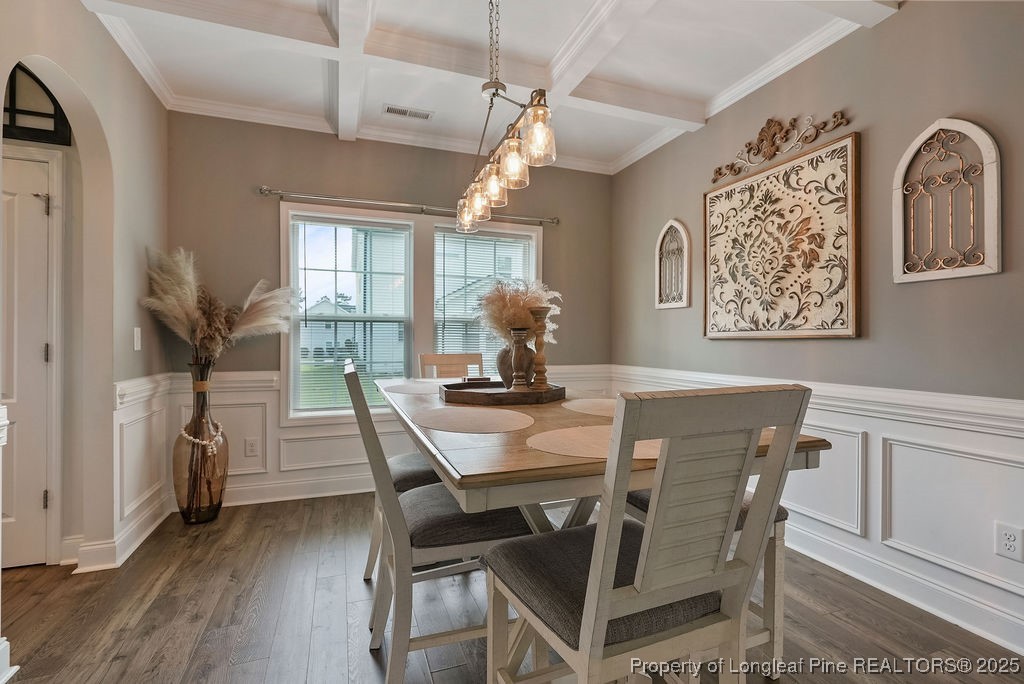 150 Timber Skip Drive Spring Lake, NC 28390 - Photo 6 of 39 a dining room with furniture a chandelier and wooden floor
