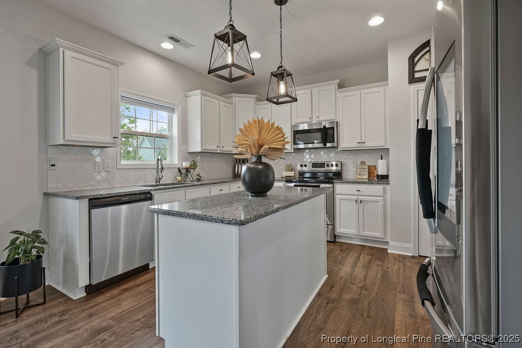 150 Timber Skip Drive Spring Lake, NC 28390 - Photo 10 of 39 a kitchen with kitchen island granite countertop a sink appliances cabinets and counter space