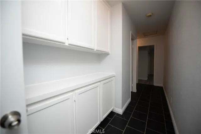 a view of a closet area with wooden floor