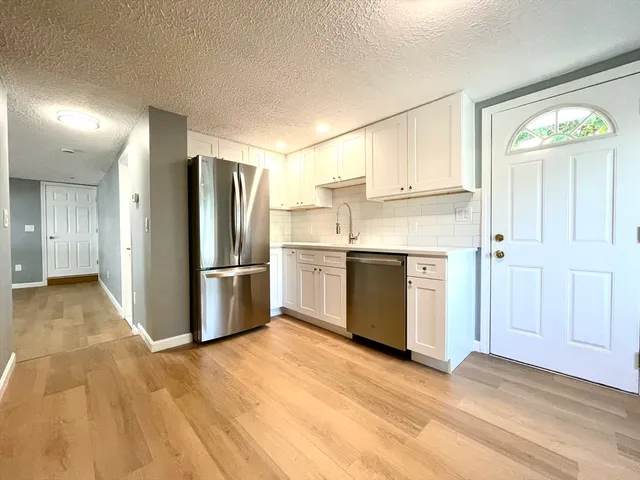 a kitchen with stainless steel appliances a refrigerator and a stove top oven