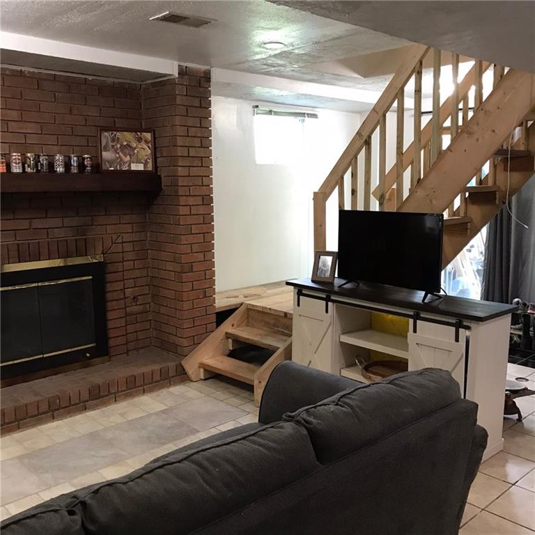 3109 Millers Run Road Cecil, PA 15321 - Photo 14 of 23 Staircase from kitchen leads to the family room or to the mudroom area that goes to the outside from the sliding glass doors. Brick fireplace can be either gas or wood burning. Cozy place for cold winter nights or just more room for entertaing!