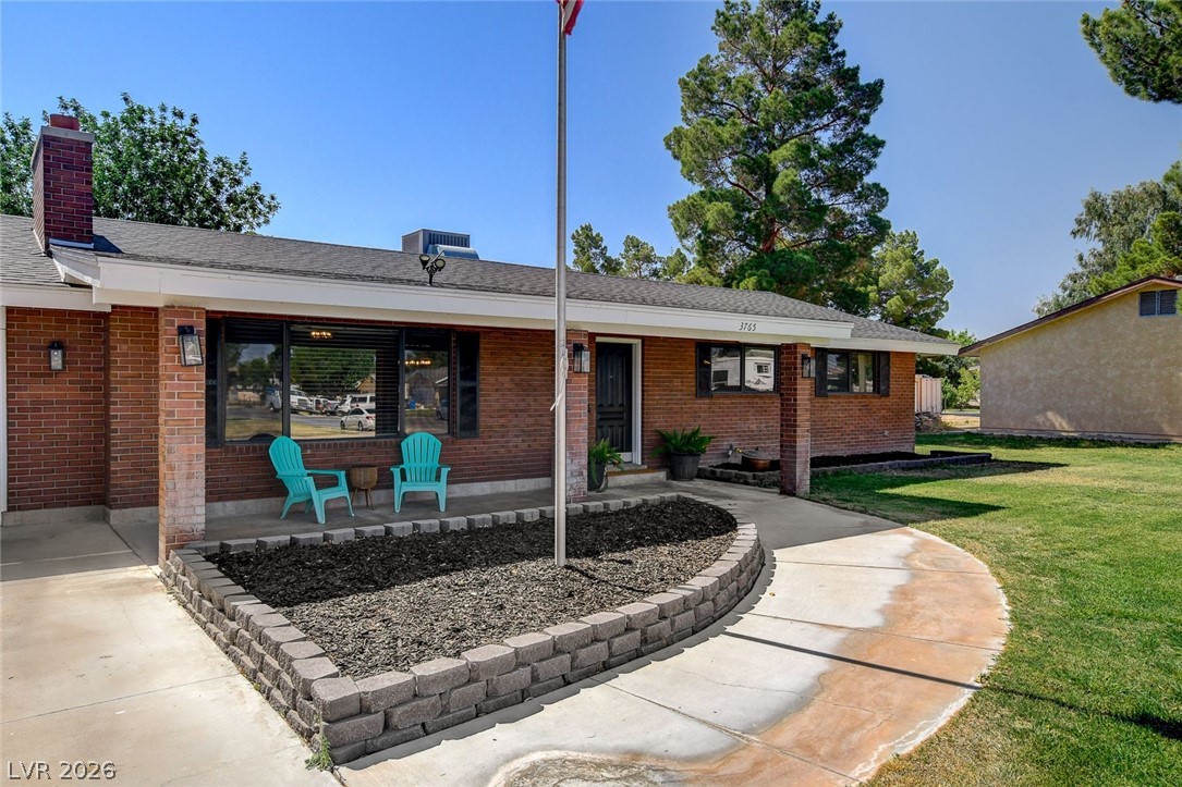3765 Berkeley Street Logandale, NV 89021 - Photo 13 of 87 This classic brick residence features a welcoming front porch and a well-maintained lawn.
