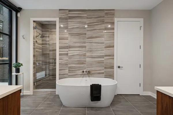 a bathroom with a bathtub and shower