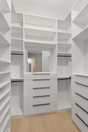 a view of walk in closet with empty racks