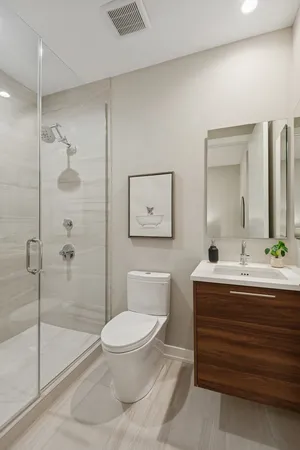 a bathroom with a toilet a sink and glass door