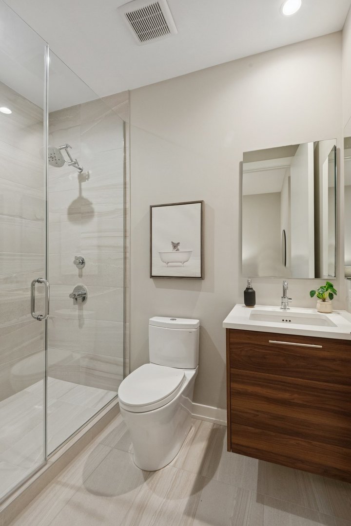 123 South Peoria Street, Unit P2 Chicago, IL 60607 - Photo 37 of 50 a bathroom with a toilet a sink and glass door