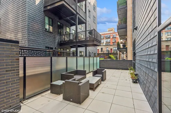 a view of a patio with a table and chairs