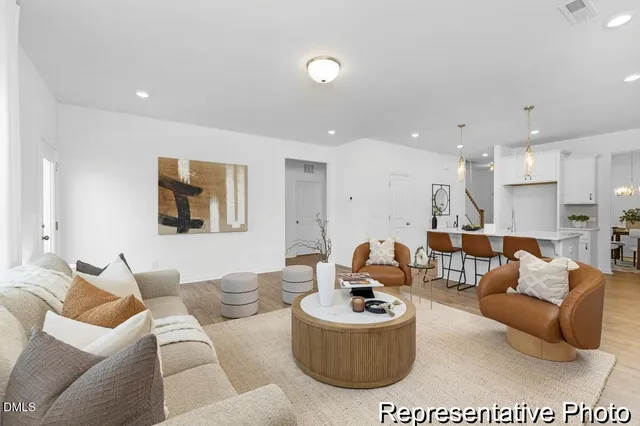 a living room with furniture kitchen and a table