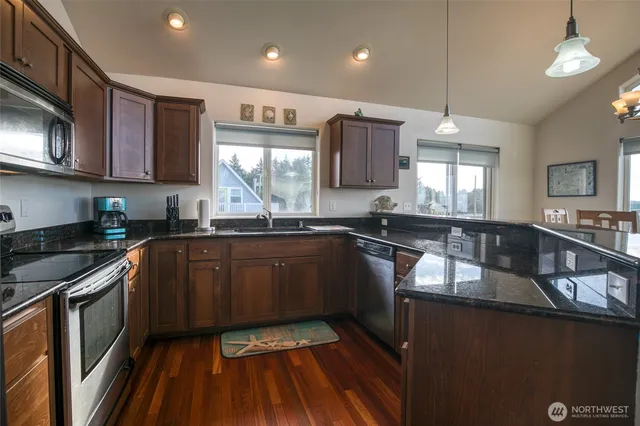 a kitchen with granite countertop stainless steel appliances and sink