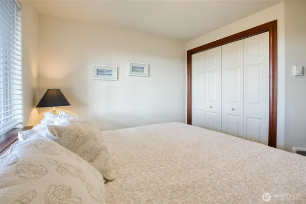 a bedroom with a bed and a lamp
