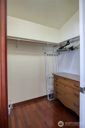 a view of walk in closet with empty racks